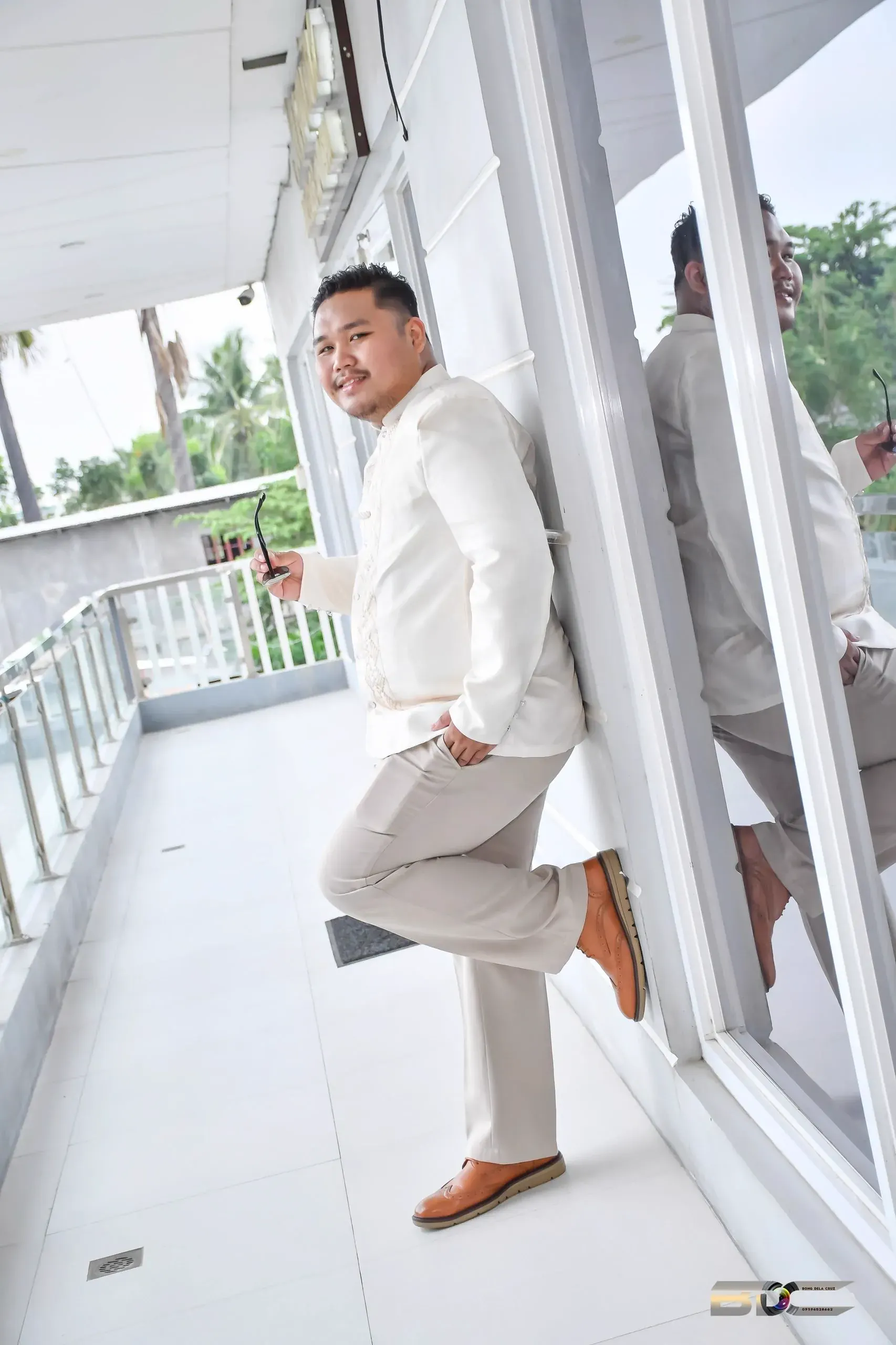 Atty. Nestor Tagulao standing beside an office window